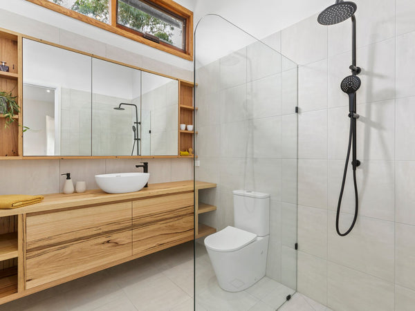 Example of a low feature Messmate timber vanity with open sherlves in a modern light grey bathroom.