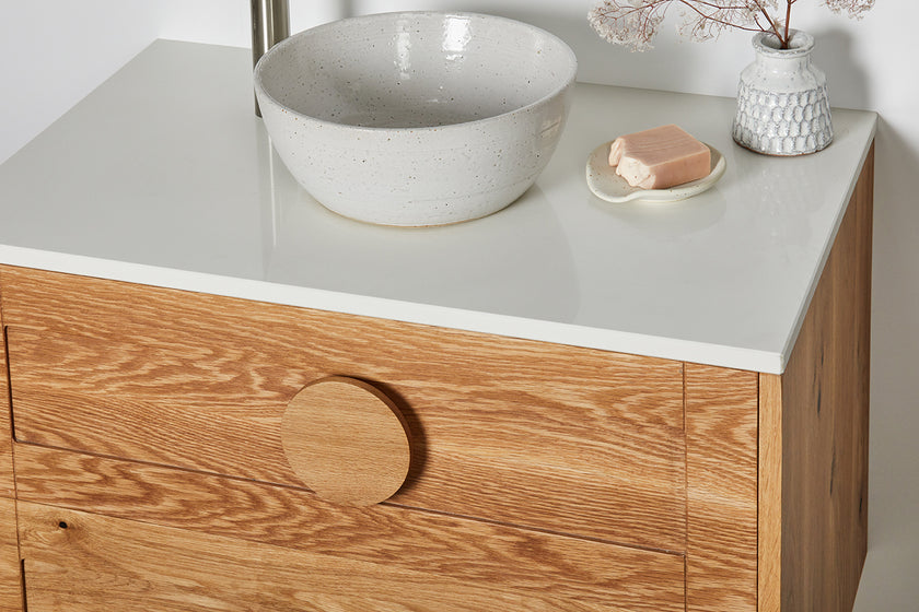 Made to order timber vanity with a round handle and stone top 