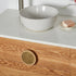 Custom timber vanity with round timber and brass handles and a white stone top 