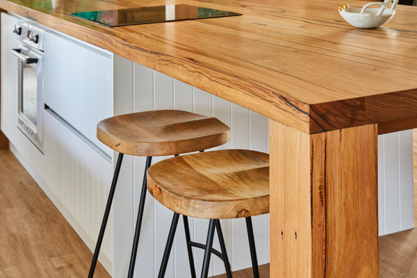 Modern farmhouse timber bench top with chunky legs. Messmate timber island bench with seating area. 