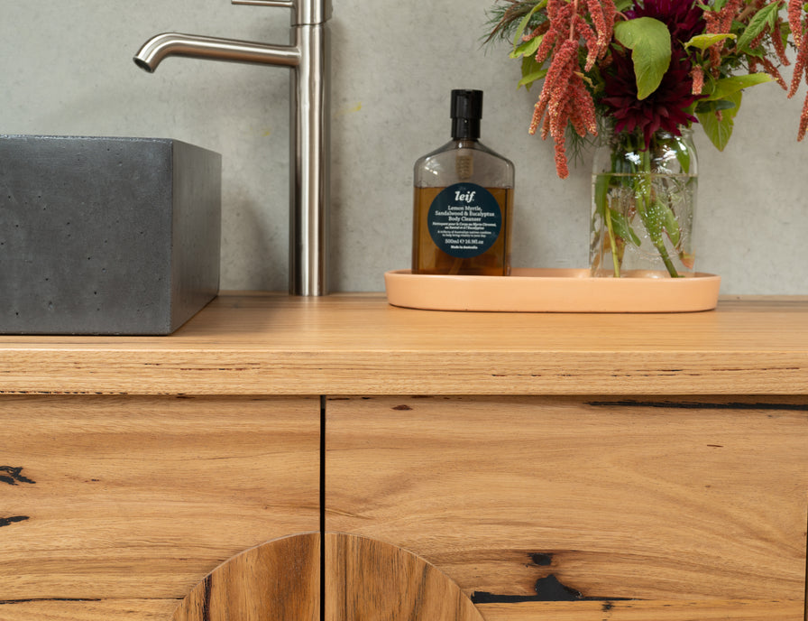 recycled timber vanity with round handles and curved ends