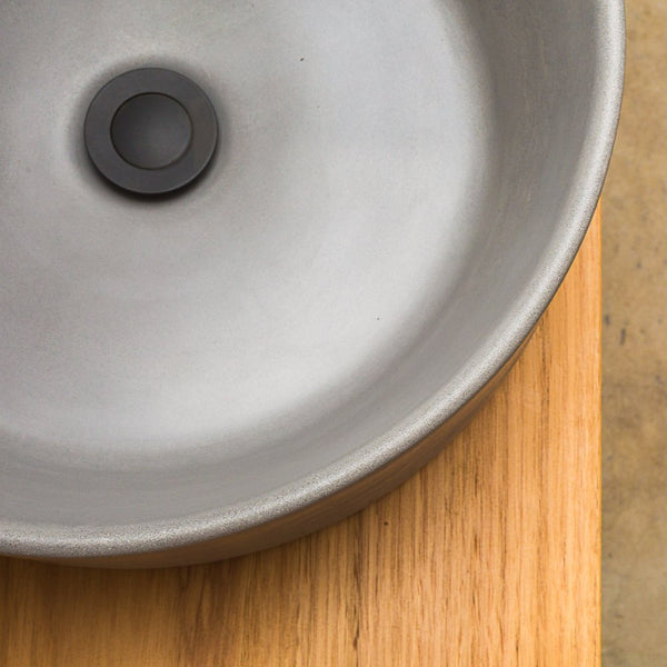 Dark grey round concrete basin