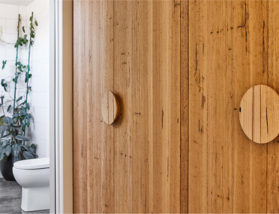 Half moon wood handles on timber wardrobe doors