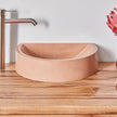 Close up of timber vanity top with black sap line features and peach concrete basin