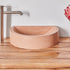 Close up of timber vanity top with black sap line features and peach concrete basin