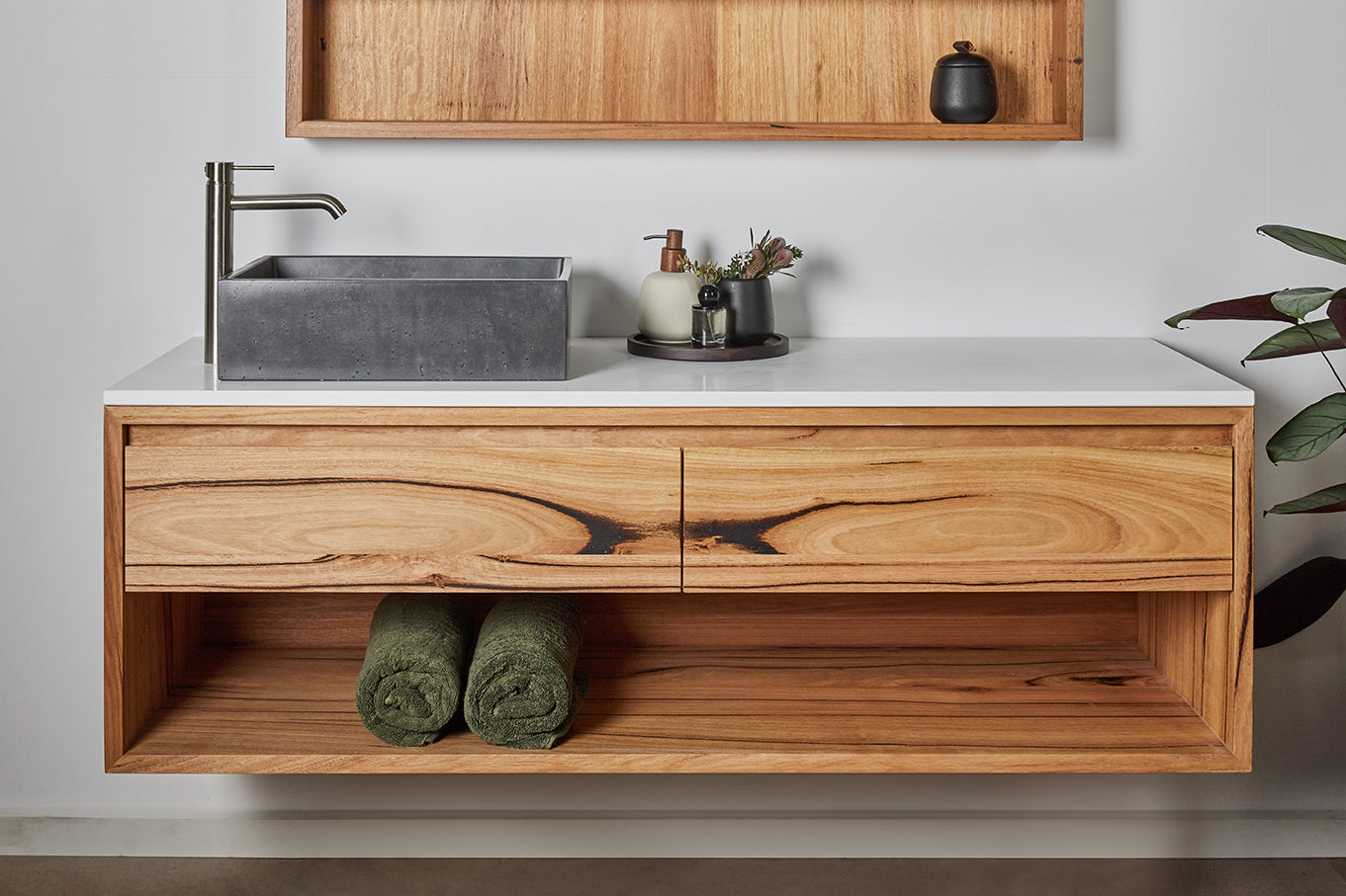 Custom made wooden vanity with white stone top and open shelf