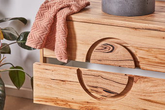 Close up of round handle detail on floating timber vanity