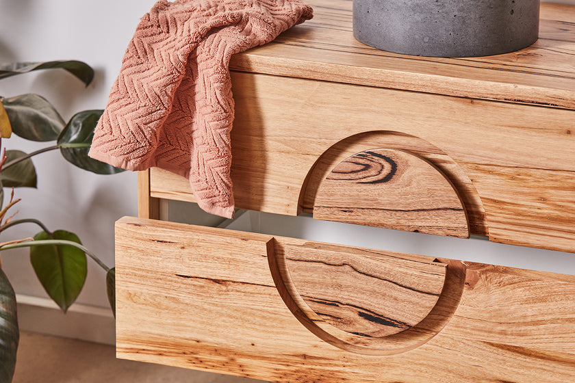 Close up of round handle detail on floating timber vanity