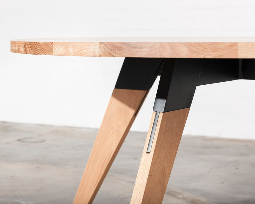 Made to order round timber dining table with metal legs