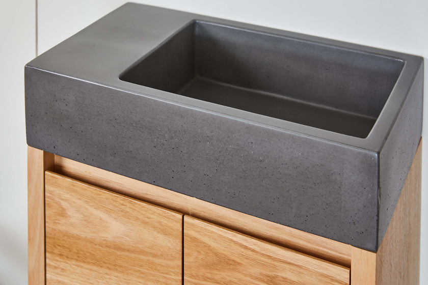 dark grey concret basin on small powder room vanity