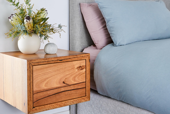 Wall mounted wooden bedside cabinet in Messmate timber