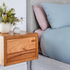Wall mounted wooden bedside cabinet in Messmate timber